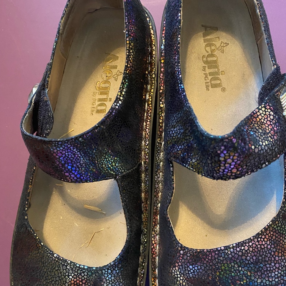 Iridescent shoes with gold buckle.